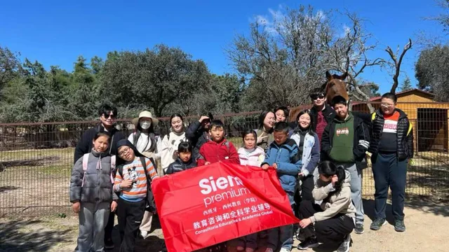 Alumnos de la academia en una excursión, con la bandera de Siempremium.